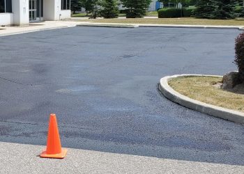 sealed parking lot around small island of grass
